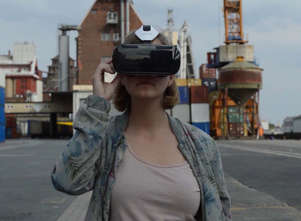 Lara wearing VR glasses and pushing a physical button
